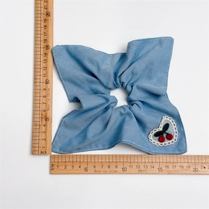 Oversized denim blue scrunchie with heart lace and cherry embroidery detail