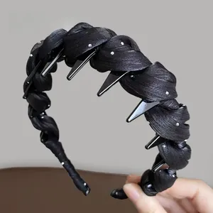 Detail of black woven satin headband featuring punk metal spikes and mini rhinestones