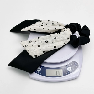 Floral print scrunchie with long ribbons weighing 18.6g on a digital scale for accuracy
