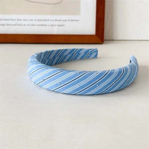 Detailed view of light blue plaid headband with small silver rhinestones and soft fabric