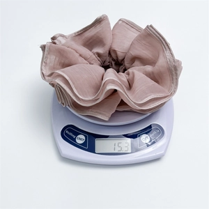 Elegant multi-layer mesh scrunchie in dusty rose weighing 15.3g on a scale