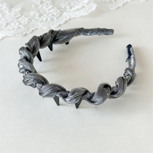 Detail of silver glitter woven headband featuring internal non-slip black plastic teeth