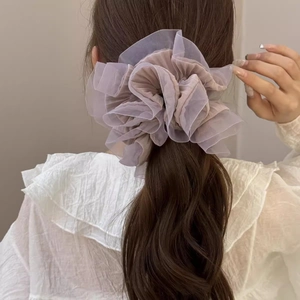 Elegant organza scrunchie in dusty rose shown on a ponytail with layered ruffle detail
