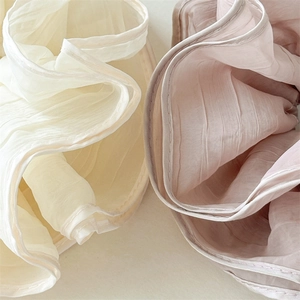 Detail of layered mesh hair scrunchies in cream and pink showing fabric texture