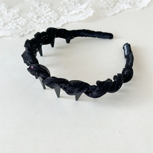 Detail view of black chiffon headband with non-slip teeth and handmade woven label