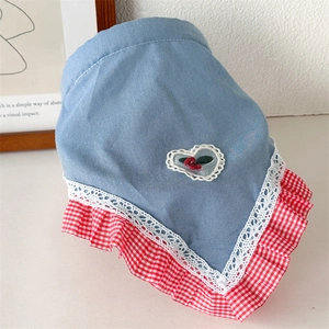 Detailed view of denim blue pet bandana with lace trim and cherry heart embroidery