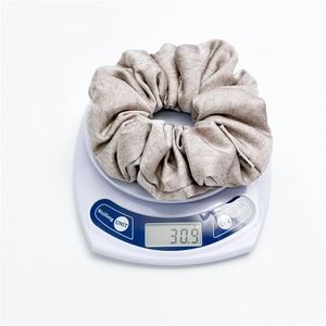 Padded oversized velvet scrunchie with marble texture on an electronic scale weighing 30.9g