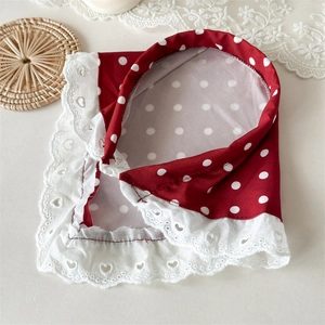 Close-up of vintage red polka dot headband with delicate white heart lace embroidery edge