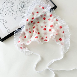 Close-up of strawberry and floral lace hair scarf with white polka dot mesh trim