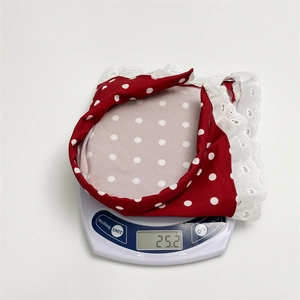 Detail shot showing the lightweight 25.2g weight of the red polka dot lace headband