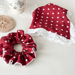 Vintage red polka dot headband set with lace trim and matching scrunchie on desk