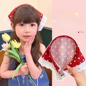 Detail of red and white polka dot headscarf headband with delicate white lace trim edge