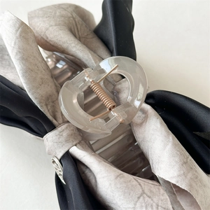 Elegant large bow hair claw clip in black satin and taupe fabric with gold metal detail