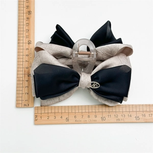 Large elegant fabric bow hair claw clip in marble and black with measurement rulers