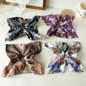 Set of four ink painting style scrunchies featuring floral and abstract artistic patterns