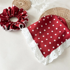 Detail of red and white polka dot headband set with delicate heart lace embroidery edges