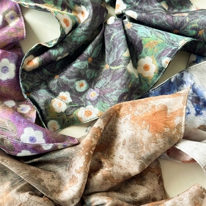 Detailed view of assorted silk satin scarves featuring Van Gogh style oil painting prints