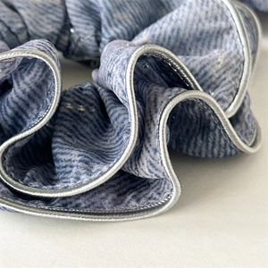 Elegant blue and white striped scrunchie with silver metallic trim for women's hair