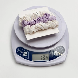 Three-piece set of purple and polka dot scrunchies weighing approximately 19.4g on scale