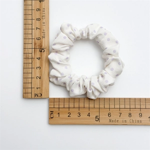 White scrunchie with purple dots and wooden ruler showing 8.5cm outer diameter size