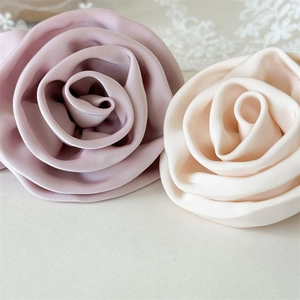 Elegant satin fabric flower hair ties in dusty pink and cream white colors for women