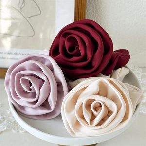 Elegant satin flower hair ties in burgundy, pink, and cream for french style ponytails