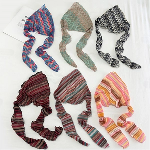 Flat lay of six colorful knitted headbands featuring zigzag patterns and striped textures