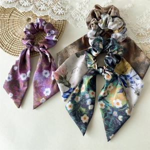 Detail of floral satin hair scrunchies with long ribbons in French vintage style