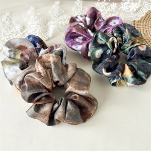 Floral and marble pattern satin scrunchies in purple, green and grey silk fabric