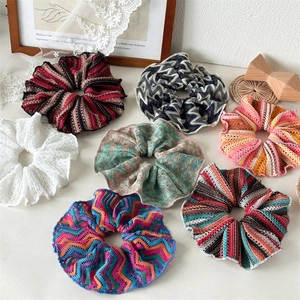 Handmade hollow knit scrunchies in various colorful patterns for a retro hair style