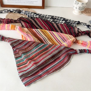 Close-up of handmade crochet hollow knit headscarves with colorful striped patterns