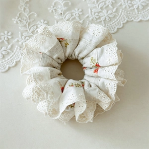 Detail of floral scrunchie with layered lace embroidery and vintage cotton fabric