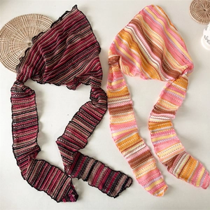 Detail of bohemian knit crochet bandanas with striped patterns and mesh texture ties