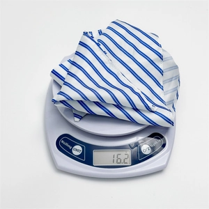 Blue and white striped fabric headscarf shown weighing only 16.2g on a scale