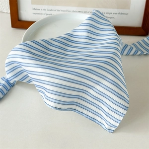 Detail showing blue and white striped fabric hair scarf with smooth silky texture
