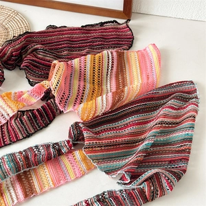 Close-up of bohemian knit headbands with striped hollow patterns in various colors