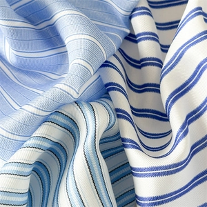 Close-up of striped fabric scarves showing blue and white patterns and soft satin texture