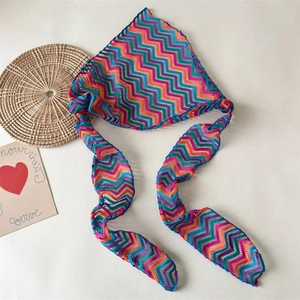Detail of bohemian knit triangle headscarf with colorful zigzag crochet pattern and ties