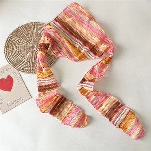 Detailed close-up of knitted crochet headscarf with vibrant colorful stripes and mesh texture
