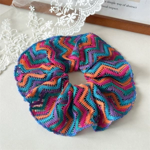 Detail of colorful hollow knit scrunchie with wave pattern and high elasticity texture