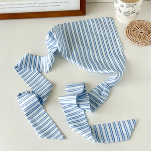 Detail shot of blue and white striped silk ribbon scarf for hair and bag styling
