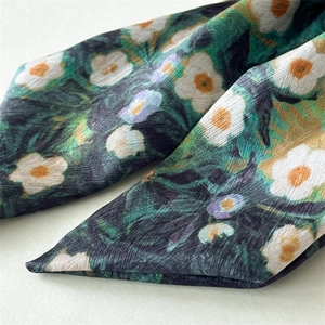 Macro shot of Van Gogh style floral satin fabric showing fine texture and soft sheen