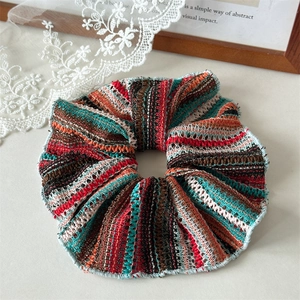 Close-up of knit striped oversized hair scrunchie with detailed stitching edges