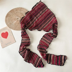Close-up of knitted striped bandana with red, black and khaki hollow crochet texture