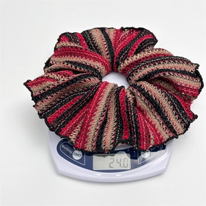 Macro view of striped knitted scrunchie on electronic scale showing 24.0g weight