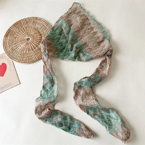 Close-up of bohemian knit headscarf featuring retro striped mesh pattern and tie-up details