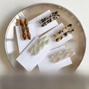 Close-up of acetic acid twist hair clips in various colors on display card