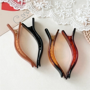 Detail view of colorful jelly texture hair clips on an elegant lace background