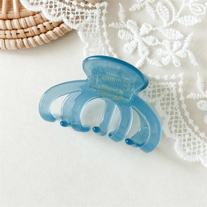 Detailed macro view of a light blue acetate octopus claw clip with France Handmade gold stamp