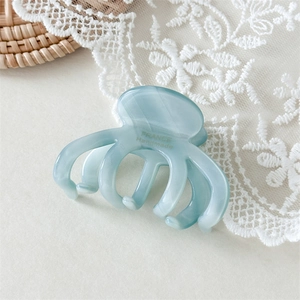Detail of marble blue acetate octopus hair claw clip with France Handmade lettering